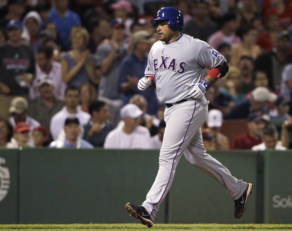 Rangers' Bengie Molina heads home on his grand slam against the Red Sox during the fifth inning in Boston, Friday.(AP Photo/Charles Krupa)