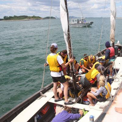 Instructor Jane Schenk helps the students disembark. (Jess Bidgood for WBUR) 