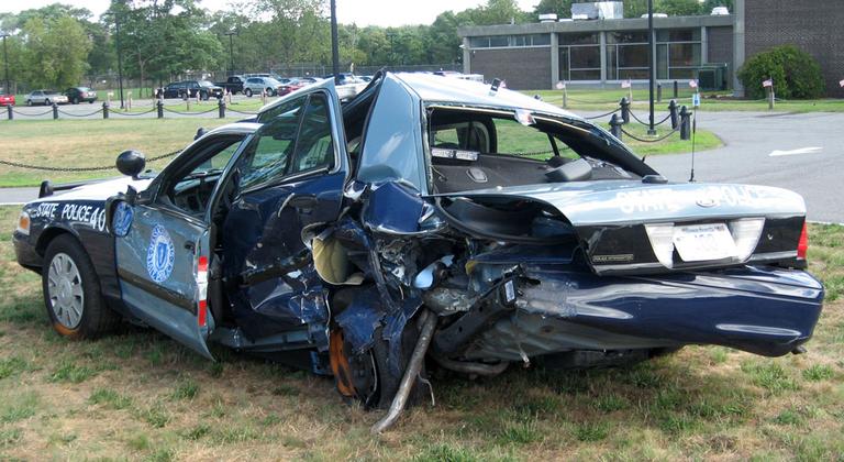 State Police on Thursday displayed Trooper Corey Rose&#039;s totaled cruiser. He was struck by an allegedly drunk driver while pulled over on Route 24 in Taunton last weekend. (Curt Nickisch/WBUR)