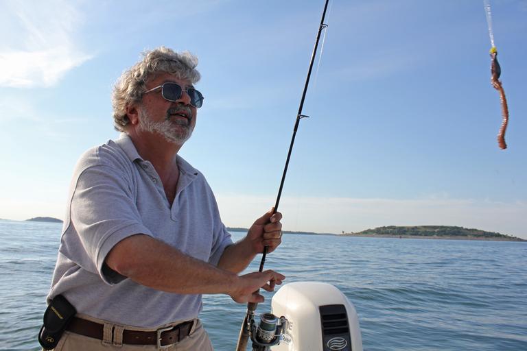 Bruce Berman, spokesman for Save The Harbor/Save The Bay, uses live seaworms to fish for striped bass in Boston Harbor. (Lisa Tobin/WBUR)
