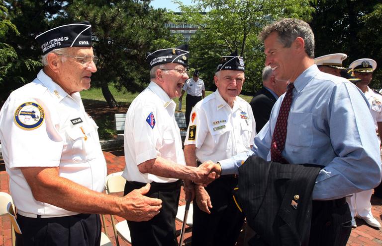 Sen. Scott  Brown, right, shakes hands with Korean War veterans Wallace Decourcey, of Newton, left, Jack Dowd, of Somerville, center, and Joe McCallion, of Wakefield, on June 25, after a Korean War ceremony in Charlestown. (AP)