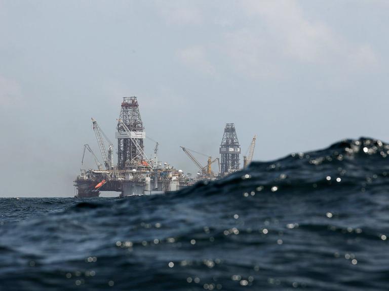 Waves partially obscure the Development Driller II (left) and Development Driller III, which are drilling the relief wells at the Deepwater Horizon oil spill site in the Gulf of Mexico. (AP)