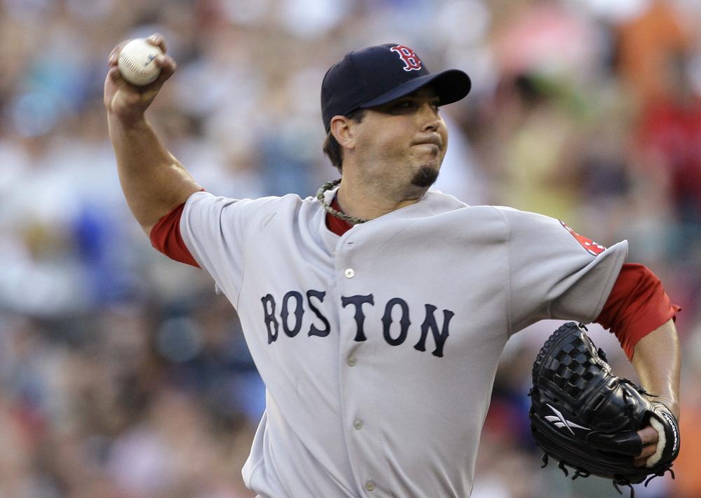 Josh Beckett throws against the Mariners in the first inning  Friday in Seattle. (AP Photo/Elaine Thompson)