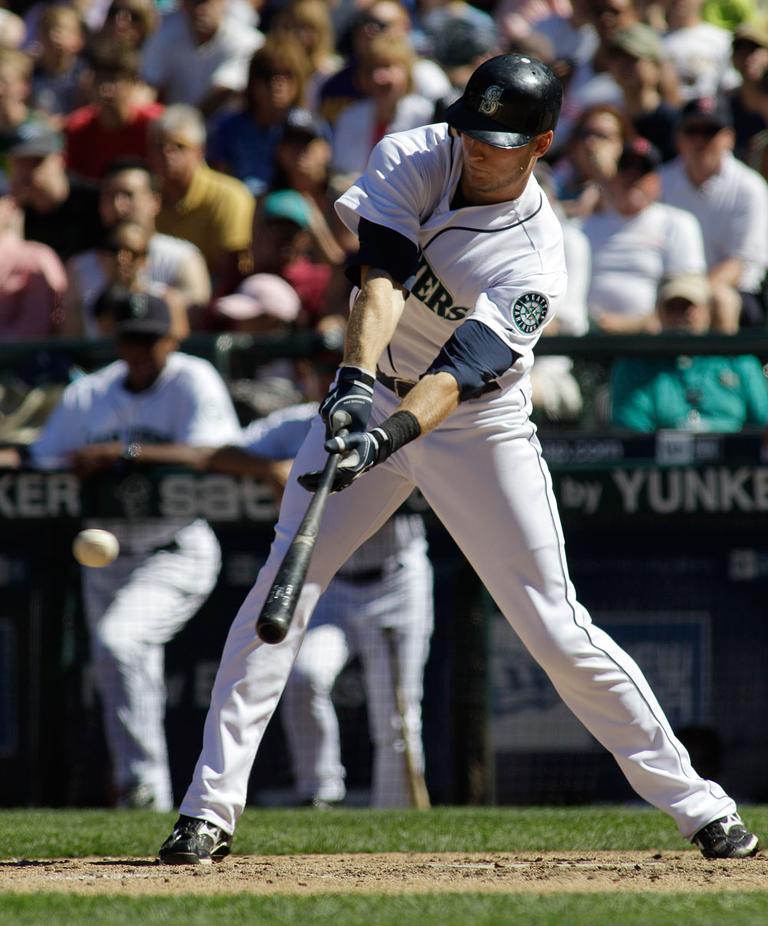 Seattle Mariners&#39; Michael Saunders lines a two-run single against the Boston Red Sox in the eighth inning on Sunday in Seattle. (AP)