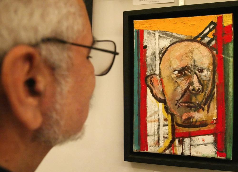 In this March 2006 file photo, a man looks at a self-portrait by William Utermohlen, who painted a series of self-portraits to document the progressive ravaging of his brain by Alzheimer's disease. (Joseph Kaczmarek/AP)
