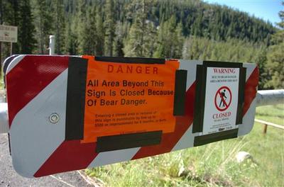 A sign at the entrance of the Soda Butte Campground outside Cooke City, Mont. warns would-be visitors to stay out after a man was killed and two people injured when a bear rampaged through the campground. (AP)
