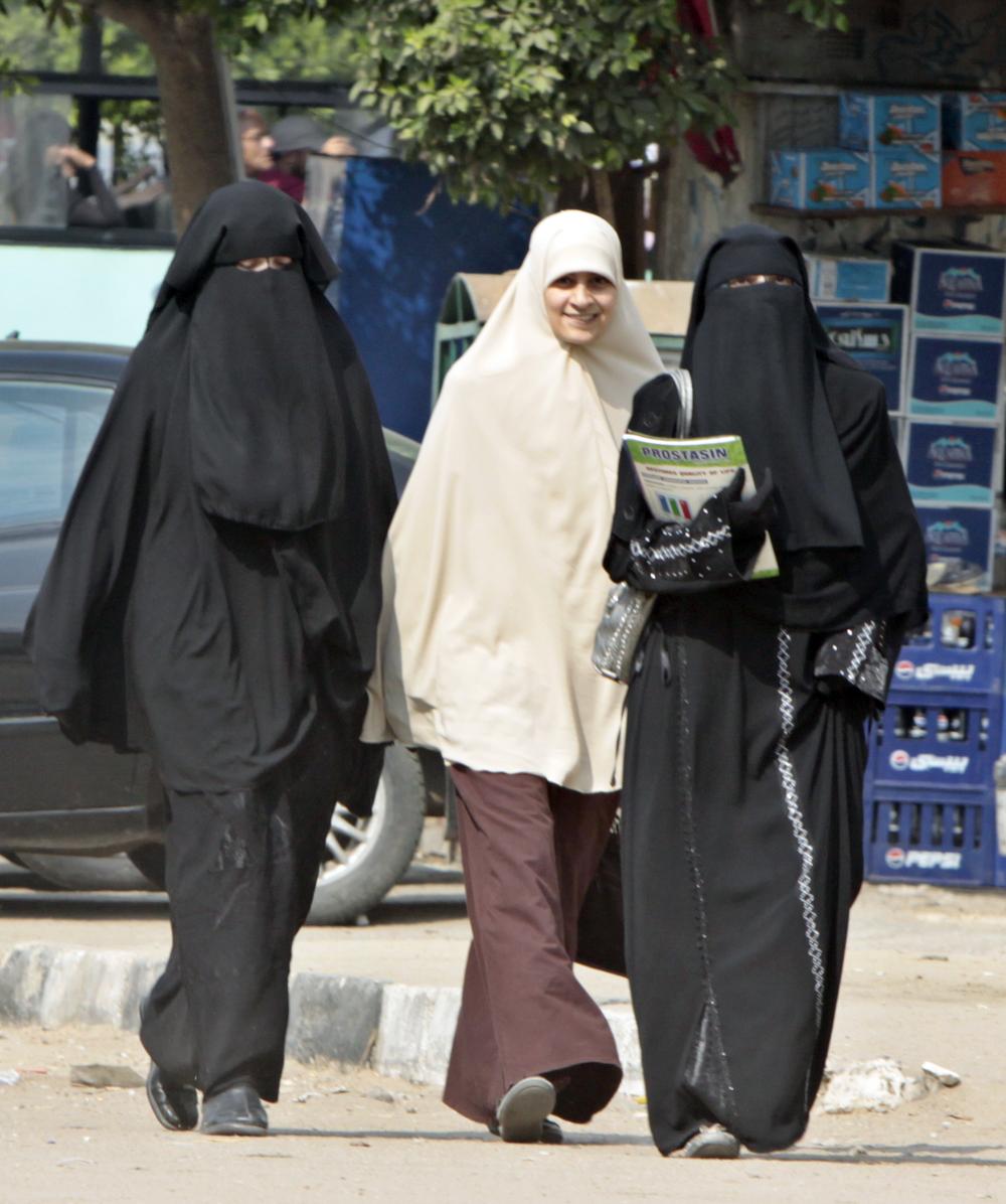 Students wearing the niqab walk with another wearing the &quot;Khemar&quot; in Cairo, Egypt. (AP)