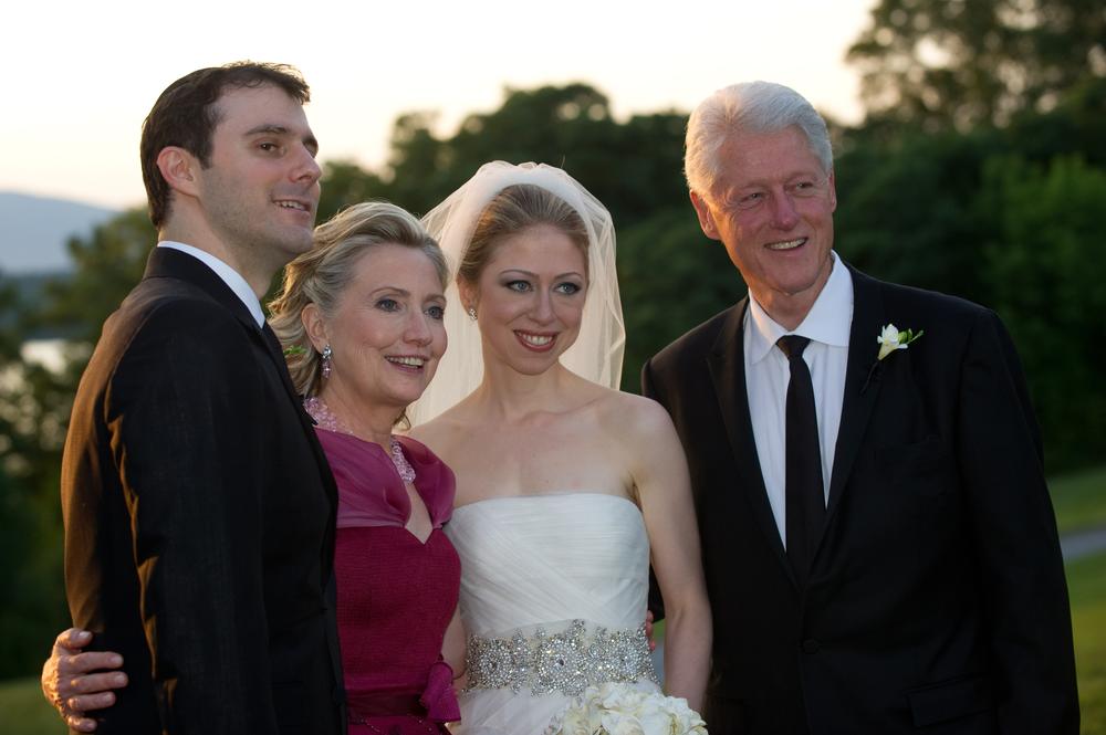 This photo released by Genevieve de Manio Photography shows Marc Mezvinsky, left, with his new mother-in-law, Hillary Rodham Clinton, his bride, Chelsea, and father-in-law former President Bill Clinton after the couple was married on Saturday.