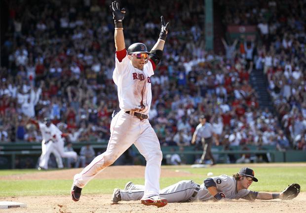 Boston&#39;s Marco Scutaro celebrates his game winning bunt single which scored Darnell McDonald with the winning run on a throwing error by Detroit pitcher Robbie Weinhardt that second baseman Will Rhymes couldn&#39;t handle at first base during the ninth inning of Boston&#39;s 4-3 win in the game in Boston on Sunday. (AP)