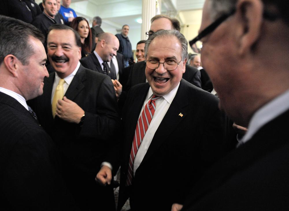House Speaker Robert DeLeo talks with supporters after announcing his proposal to allow gambling casinos and slot machine parlors at racetracks in Massachusetts, at a news conference at the State House in Boston. (AP)