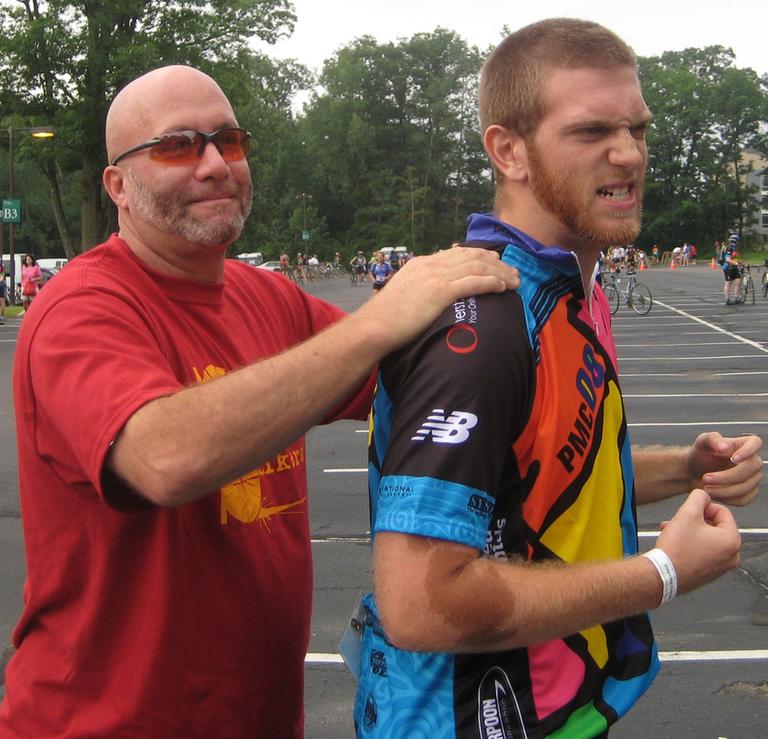 Jeremy, right, getting ready for his first PMC with a pre-ride massage from Lee Joseph. (Courtesy of Beth Fredericks.)