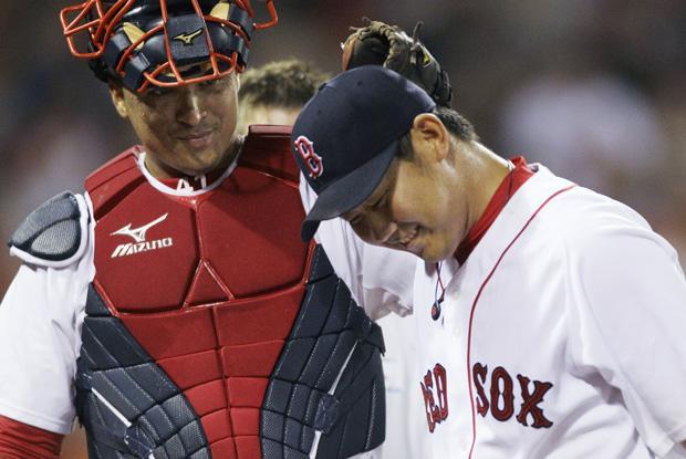 Boston catcher Victor Martinez gives starting pitcher Daisuke Matsuzaka a congratulatory tap on the head after the top of the eighth inning against Cleveland in the game in Boston on Thursday.  Daisuke allowed one run on five hits in his outing.(AP)