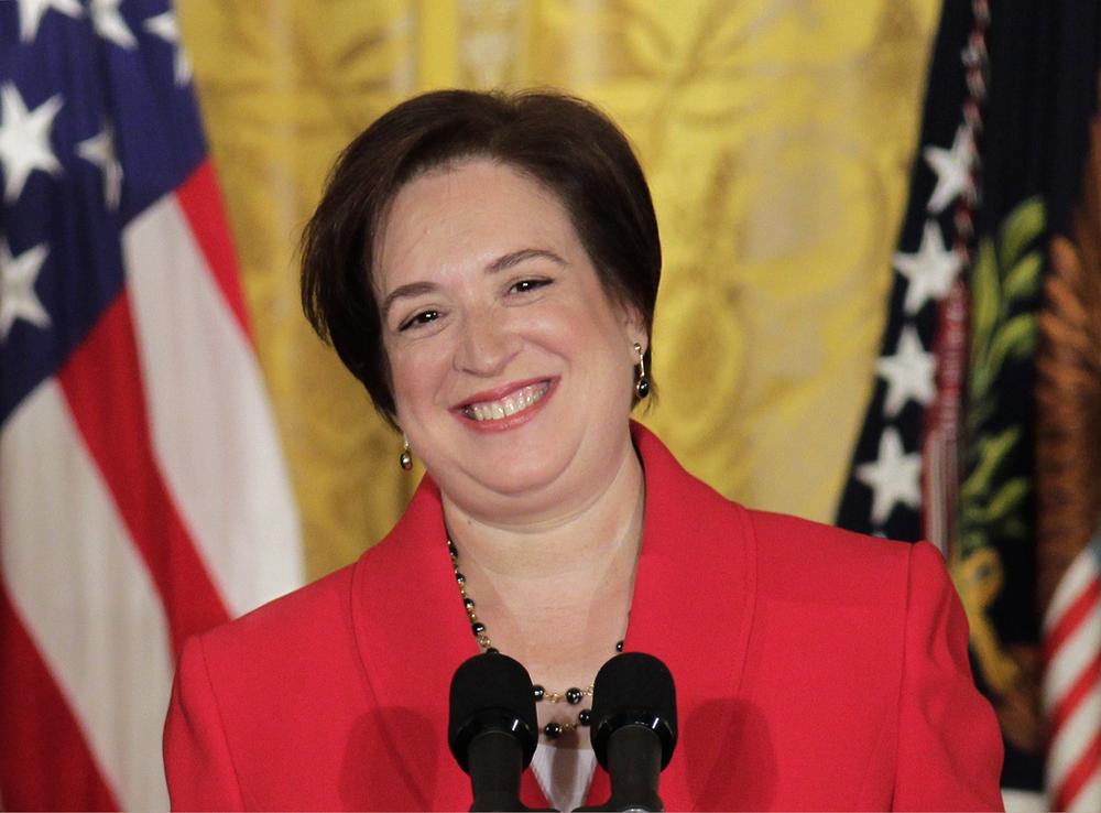 Elena Kagan smiles as she is applauded during a ceremony with President  Obama to mark her confirmation to become the next Supreme Court justice, Friday in the East Room of the White House. (AP Photo/J. Scott Applewhite)