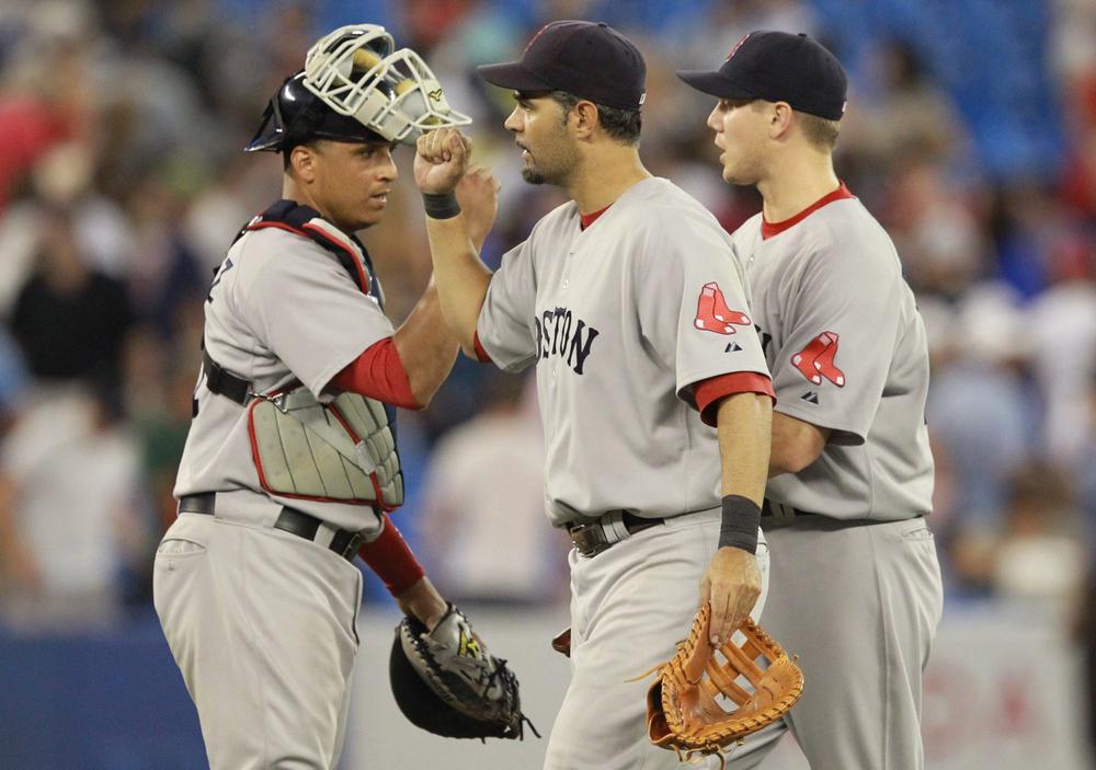 Boston's Victor Martinez, Mike Lowell, and Jonathan Papelbon celebrate the Red Sox's 7-5 victory over Toronto during a game in Toronto on Tuesday. (THE CANADIAN PRESS/AP)