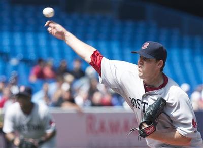 Boston Red Sox starter John Lackey throws a pitch against the Toronto Blue Jays during the first inning in Toronto on Thursday. (AP/The Canadian Press)