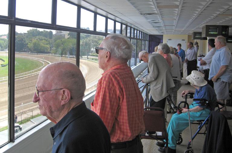 North Hill residents watch a horse race at Suffolk Downs in East Boston. (Bill Littlefield/WBUR)