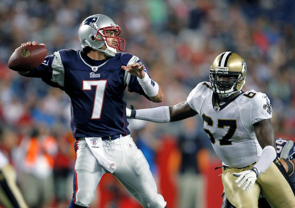 New England Patriots&#39; Zac Robinson (7) passes the ball under pressure from New Orleans Saints&#39; Junior Galette in the second half of an NFL preseason football game in Foxborough on Thursday. The Patriots won 27-24. (AP)