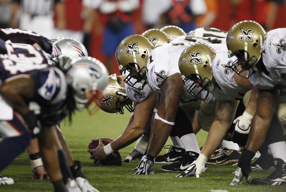 The New England Patriots line up at the line of scrimmage against the New Orleans Saints  during the first half of an NFL preseason football game in Foxborough on Thursday. (AP)