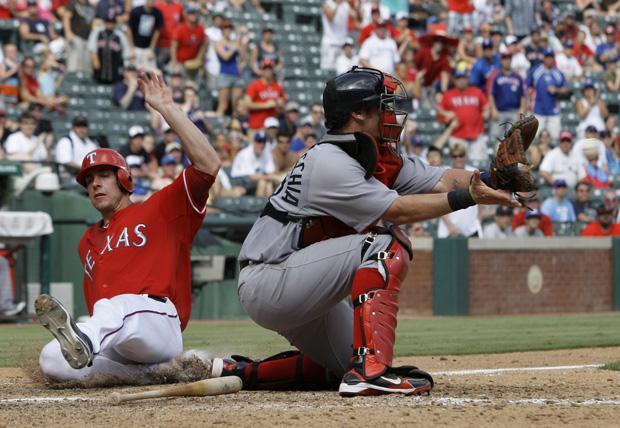Boston catcher Jarrod Saltalamacchia reaches out for the throw as Texas' Taylor Teagarden scores on a single by Julio Borbon in the eighth inning of the game on Sunday in Arlington, Texas. The Rangers won 7-3. (AP)