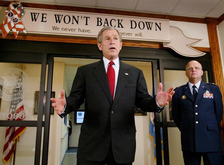 President Bush talks to reporters outside the National Security Operations Center as NSA  Director Lt. Gen. Michael Hayden looks on, in 2002. (AP)