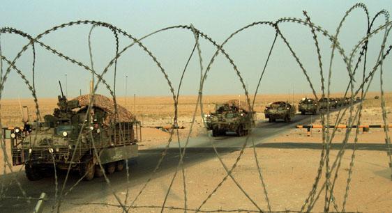 A column of U.S. Army Stryker armored vehicles cross the border from Iraq into Kuwait on Wednesday. The trucks are part of the last combat brigade to leave Iraq as part of the drawdown of U.S. forces. (AP)