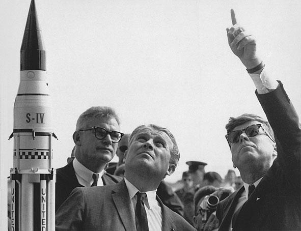 Dr. Wernher von Braun, center, explains the Saturn Launch System to President John F. Kennedy in 1963 as NASA Deputy Administrator Robert Seamans looks on. (NASA)
