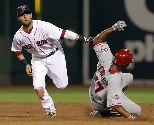 Boston second baseman Dustin Pedroia tags out Los Angeles' Howard Kendrick, who was trying to steal second base in the fourth inning of the game in Boston on Wednesday. (AP)