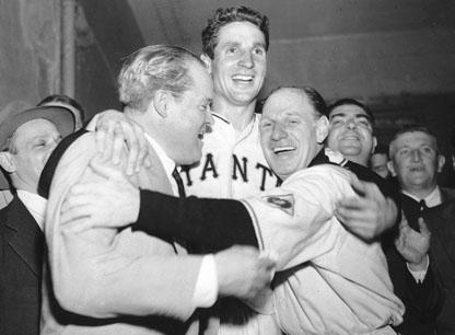 Bobby Thomson, center, celebrates with New York Giants club owner Horace Stoneham, left, and manager Leo Durocher after his &#039;shot heard round the world.&#039; (AP)