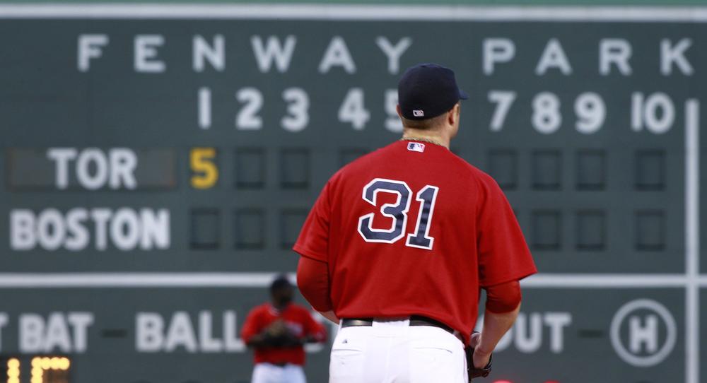 Red Sox starter Jon Lester walks back to the mound after giving up five runs in the first inning against the Toronto Blue Jays. (AP Photo/Charles Krupa)