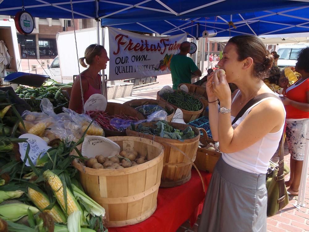 A woman sampled veggies at a farmers market at Boston's City Hall Plaza on Aug. 4. (Massachusetts Department of Agricultural Resources)