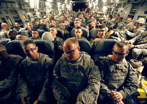 U.S. Army soldiers from 2nd Brigade, 10th Mountain Division are seen on board a C-17 aircraft at Baghdad International Airport as they begin their journey back to the United States, July 13, 2010. (AP)