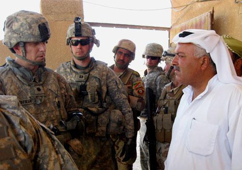 In this June 29, 2010 photo, U.S. Army Lt. Col. Richard &quot;Ross&quot; Coffman, left, talks to a village sheik in al-Bailona, Ninevah province. (AP)