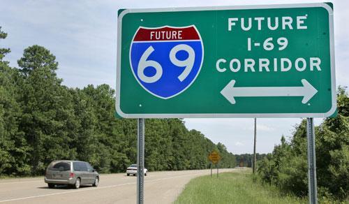 Traffic on U.S. 63 passes a road sign indicating a future crossing of proposed Interstate 69 near Warren, Ark. (AP) 