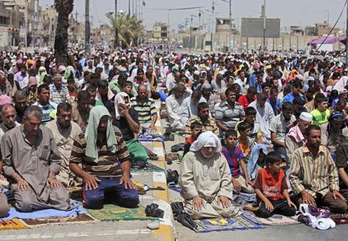 Followers of Shiite cleric Muqtada al-Sadr as they attend open air Friday prayers in Sadr City in Baghdad, Aug. 20, 2010. (AP)