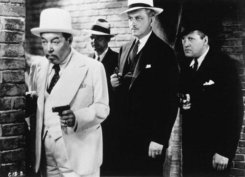 At left, Charlie Chan played by Warner Oland (Fox Home Entertainment)