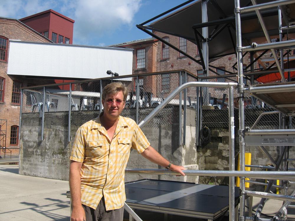 Joe Thompson, the director of MASS MoCA, stands near a construction site for the weekend&#39;s festival. (Andrea Shea/WBUR)