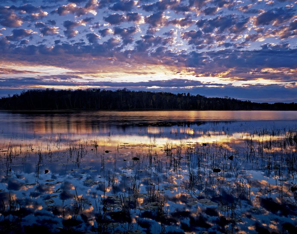 Sunset flares over Thunder Lake, one of 14 small lakes on the Red Lake Reservation in Minnesota, and sacred to the Chippewa. (© Jack Dykinga/National Geographic)