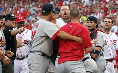 Scott Rolen of the Cincinnati Reds yells at a St. Louis Cardinals player being held back by teammate Jeff Suppan during an altercation in the first inning of their game in Cincinnati Tuesday, Aug. 10, 2010. (AP Photo/Tom Uhlman)