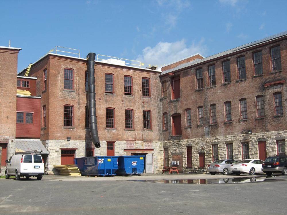 It was empty a couple of weeks ago, but the space around MASS MoCA will be transformed into a multi-stage performance venue at this weekend&#39;s Solid Sound Festival, curated by Wilco. (Andrea Shea/WBUR)