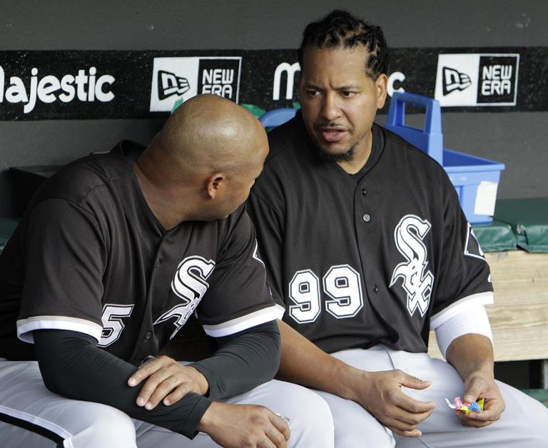 New Chicago White Sox Manny Ramirez, right, talks with teammate Andruw Jones in the dugout. (AP)
