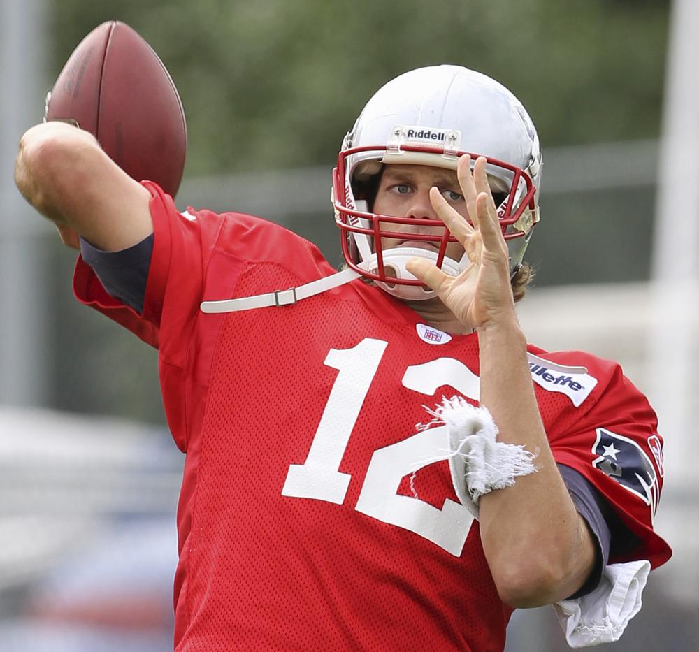 Tom Brady (12) works a passing drill during practice at the NFL football team's facility in Foxborough, Thursday afternoon. (AP Photo/Stephan Savoia)