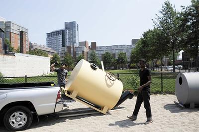 Matthew's buddies, Paul and Jegan, unload the tanks at the park. (courtesy photo)