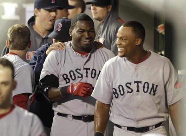 Boston Red Sox's David Ortiz, center, and Adrian Beltre, right, celebrate in the dugout after Ortiz scored in the second inning against the Seattle Mariners in a baseball game, Tuesday, Sept. 14, 2010, in Seattle. (AP)
