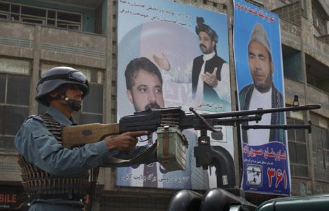 A policeman stands guard a day ahead of parliamentary elections in Kabul. (AP)
