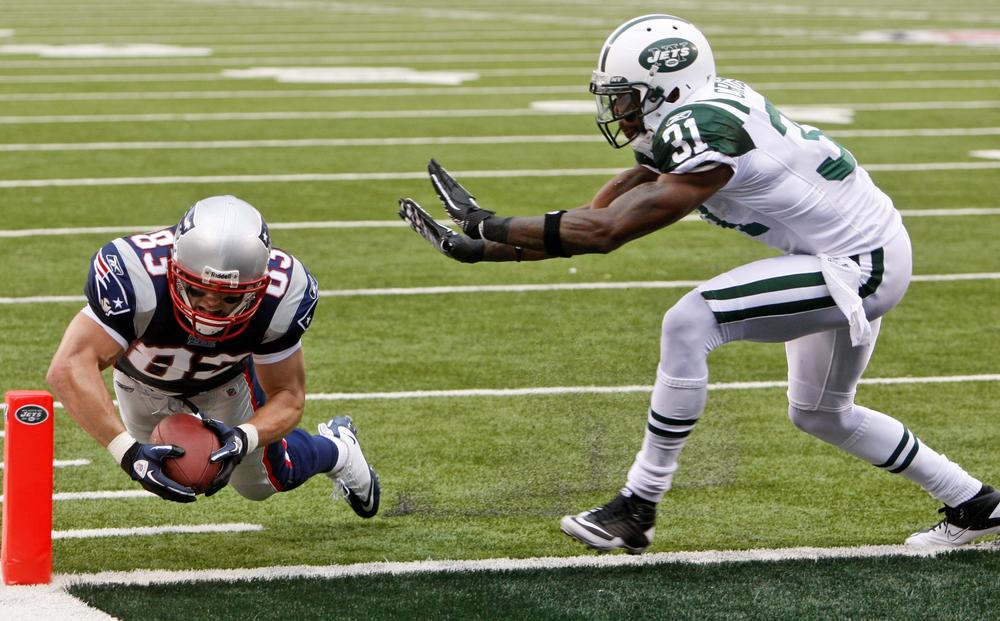 New England Patriots wide receiver Wes Welker scores a touchdown as New York Jets' Antonio Cromartie attempt to make the tackle during the second quarter of an NFL football game at New Meadowlands Stadium in East Rutherford, N.J. on Sunday. (AP)