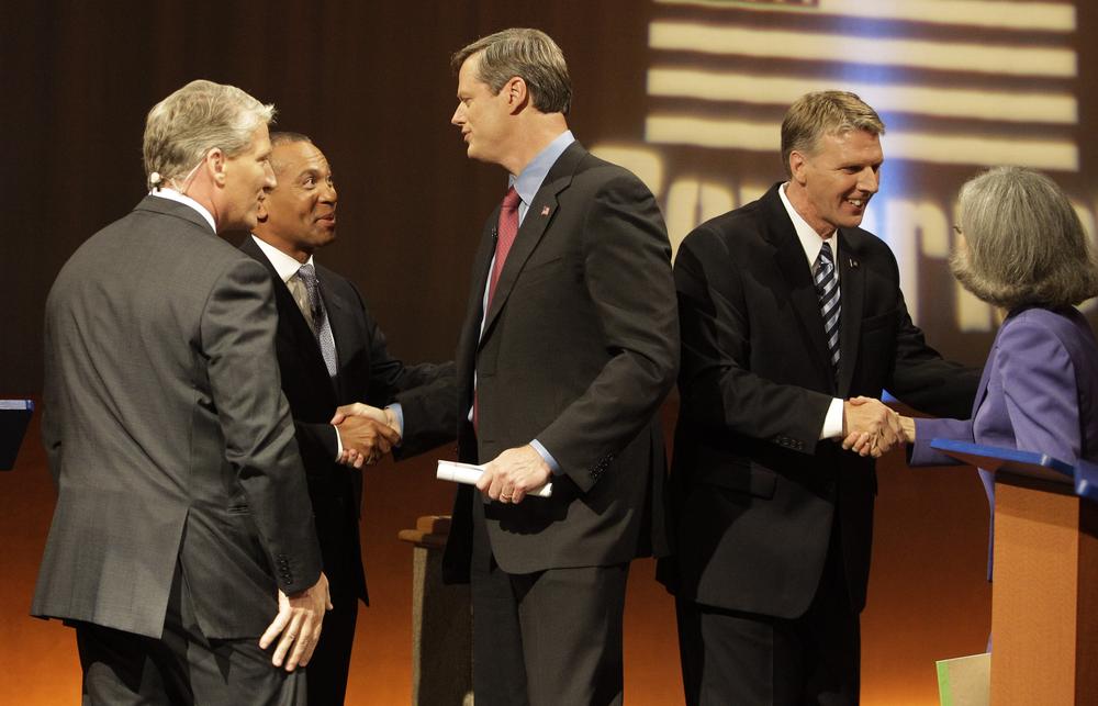 The four gubernatorial candidates and debate moderator shake hands after a gubernatorial debate Tuesday night. From left to right: CNN host and debate moderator John King, incumbent Gov. Deval Patrick, Republican Charles Baker, independent Timothy Cahill, Green-Rainbow Party candidate Jill Stein. (AP)