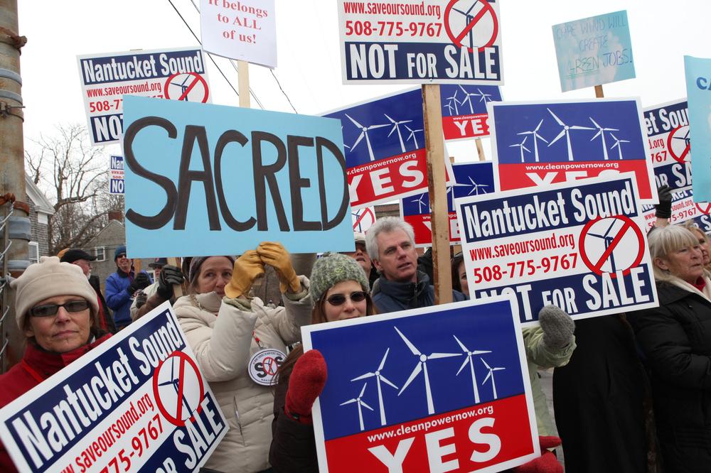 Supporters and opponents of Cape Wind protest outside the Coastguard Station in Woods Hole on Feb. 2. (AP)