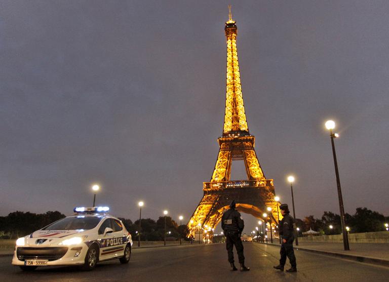 Police officers stand by the Eiffel Tower in Paris after it was evacuated thanks to a bomb threat. (AP)