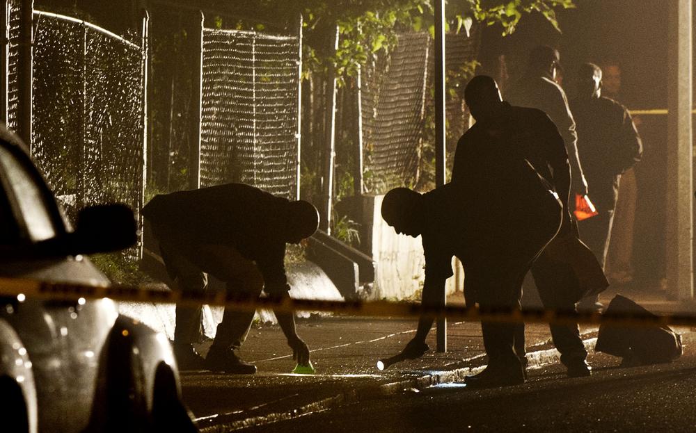 Boston Police detectives search for evidence after a pre-dawn shooting Tuesday, Sept. 28. (AP)