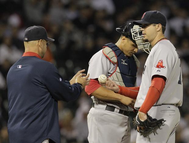 Boston Red Sox manager Terry Francona, left, relieves starting pitcher Josh Beckett, right, as catcher Victor Martinez, looks on during the seventh inning of a baseball game against the Chicago White Sox on Wednesday in Chicago. (AP)